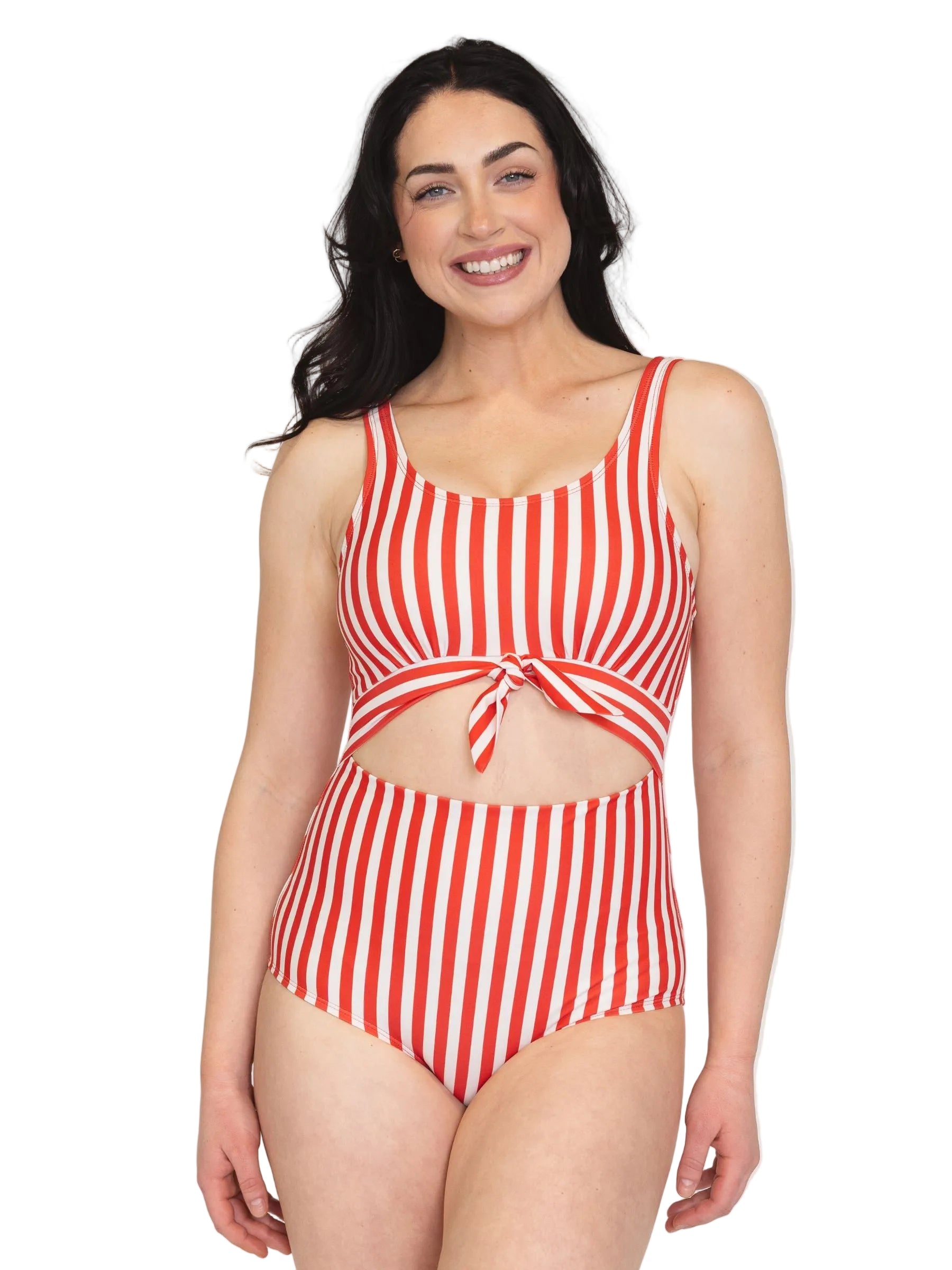 Woman wearing a red and white striped swimsuit on a plain background