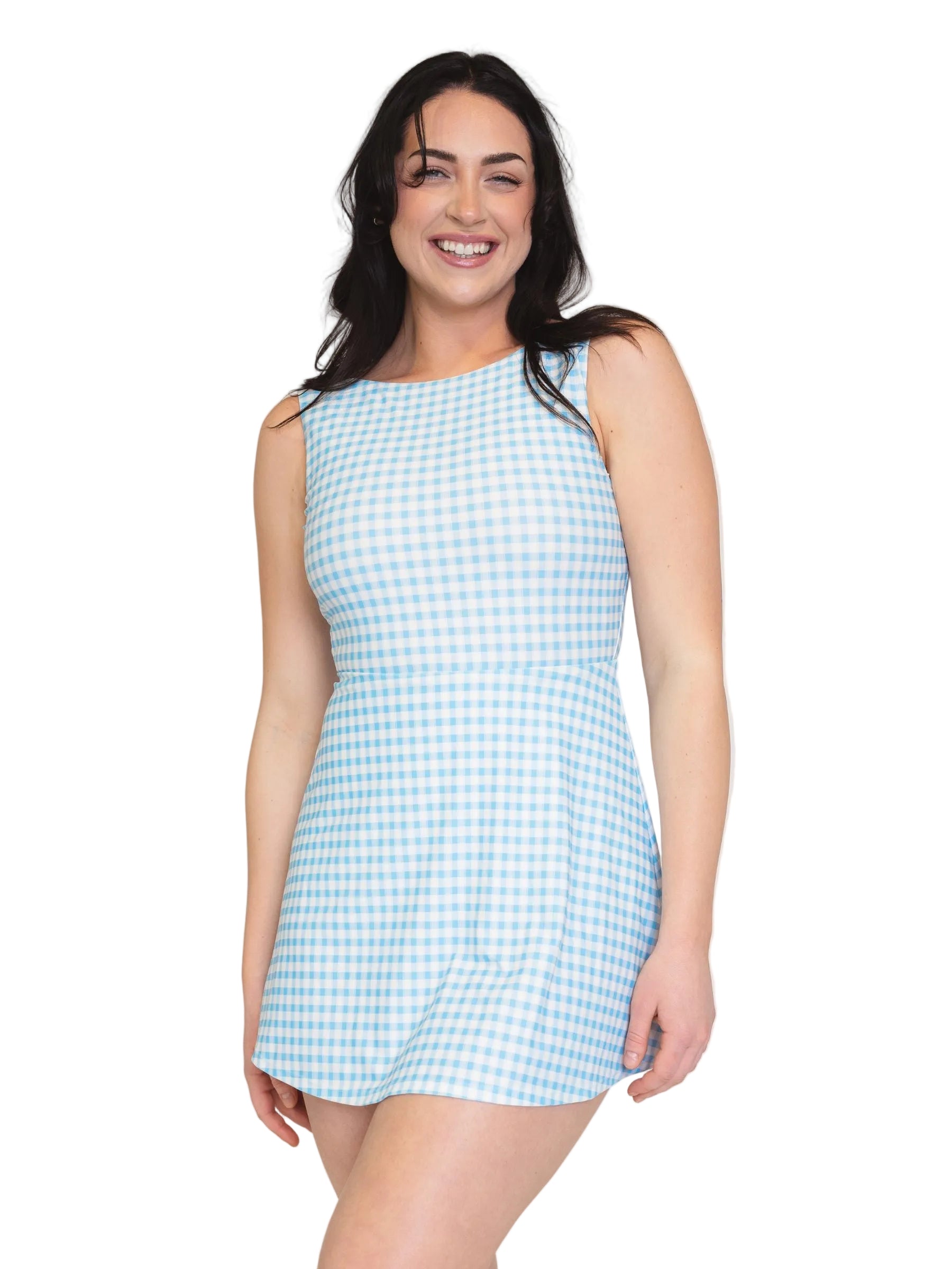 Woman wearing a light blue checkered dress against a plain background