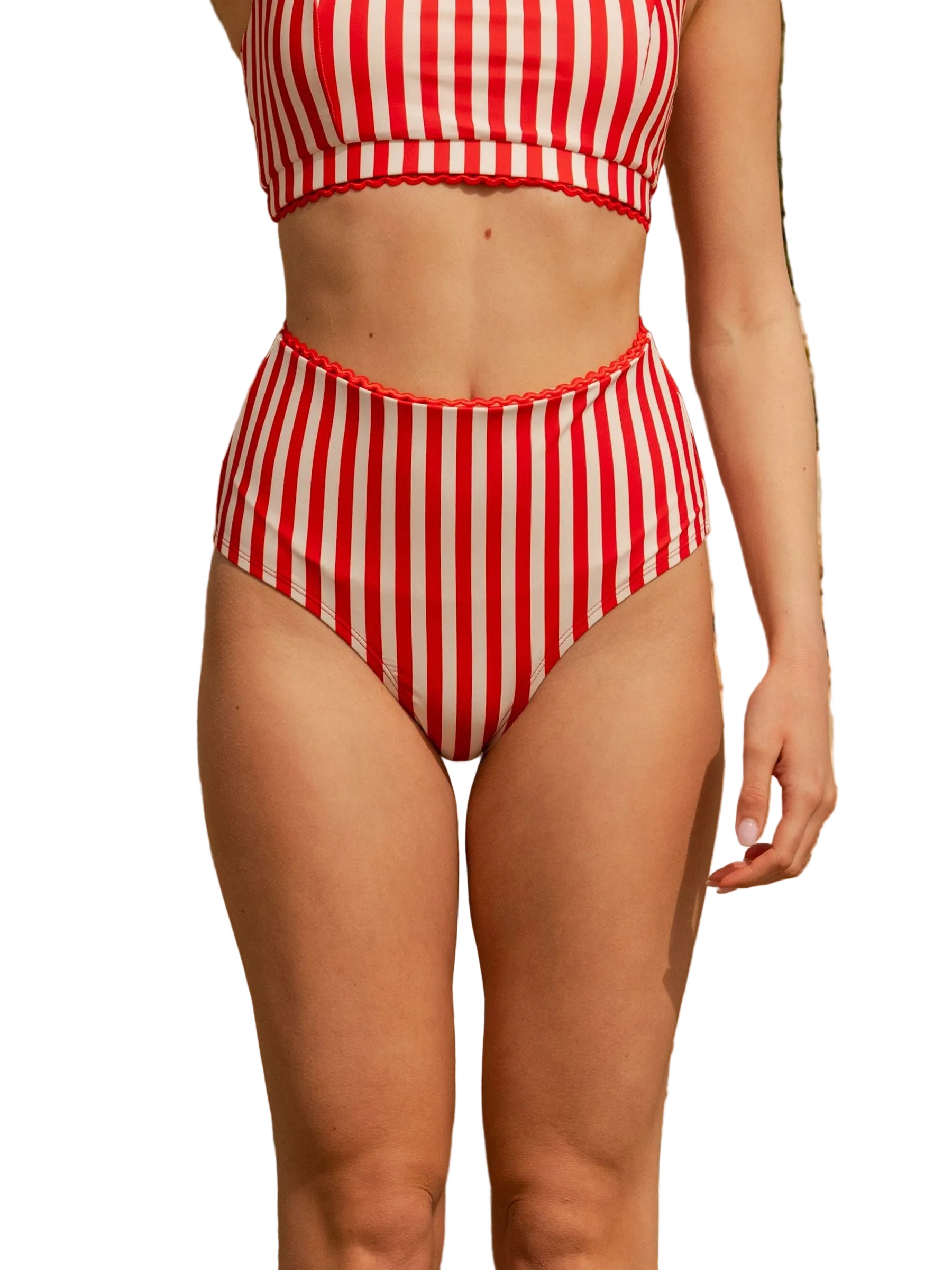 Girl wearing a red and white striped bikini set with a natural background