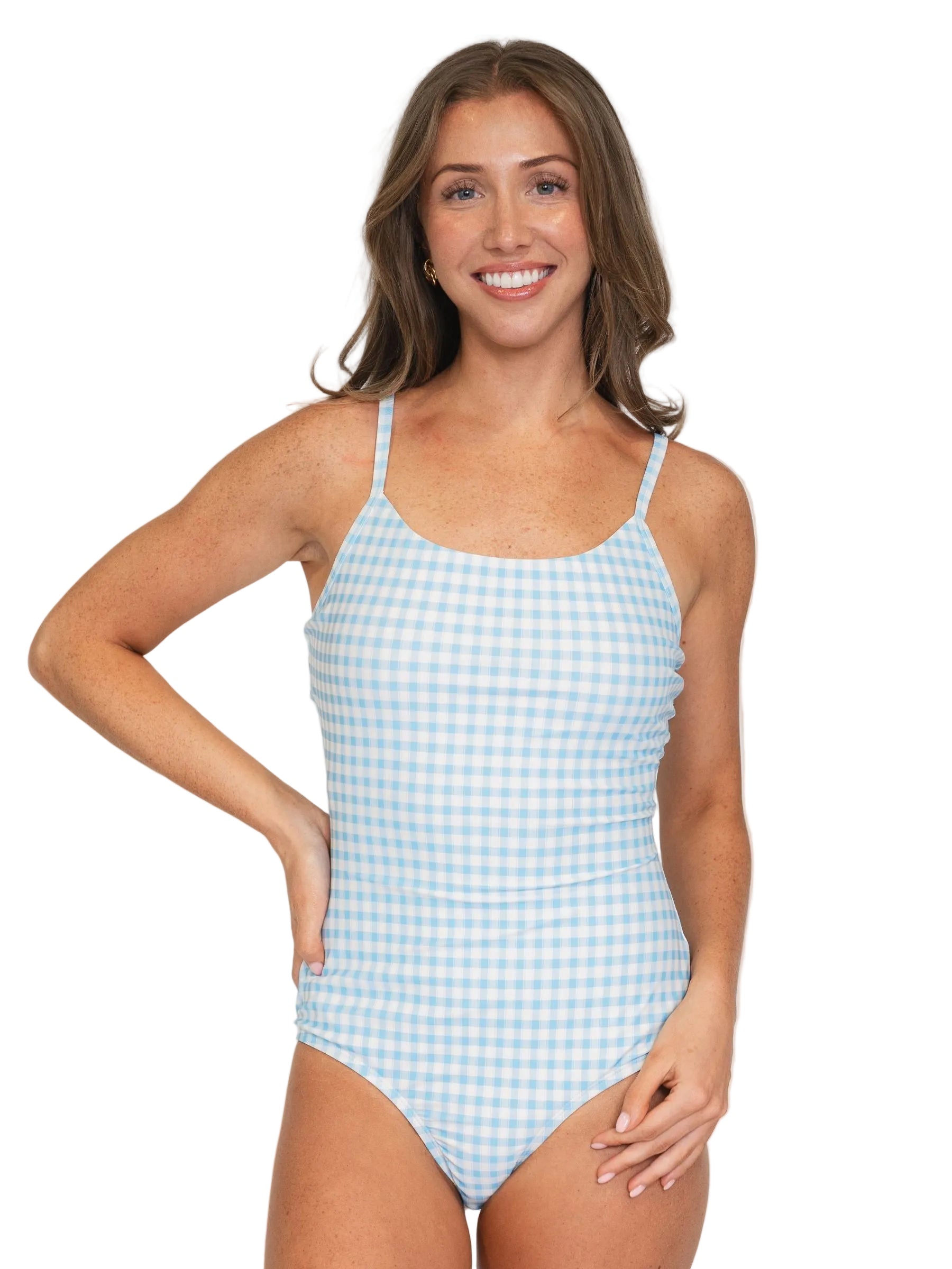 Woman wearing a blue and white checkered swimsuit against a plain background