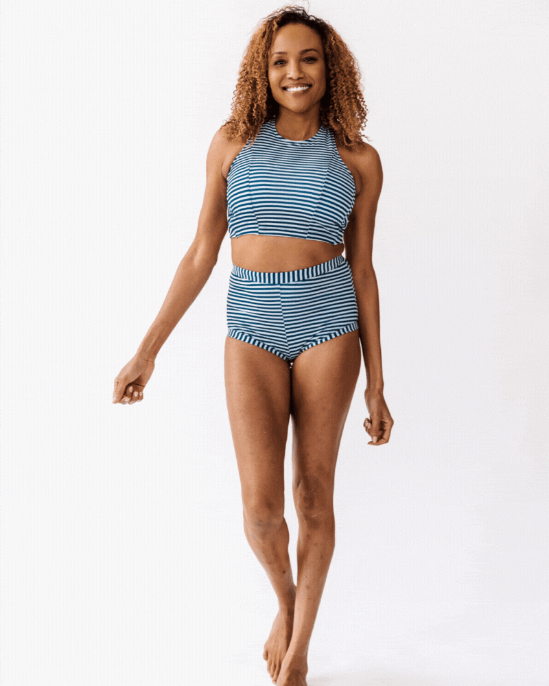 GIF of a woman wearing an Indigo stripe cross-back swim crop top and an Indigo stripe swim short bottom