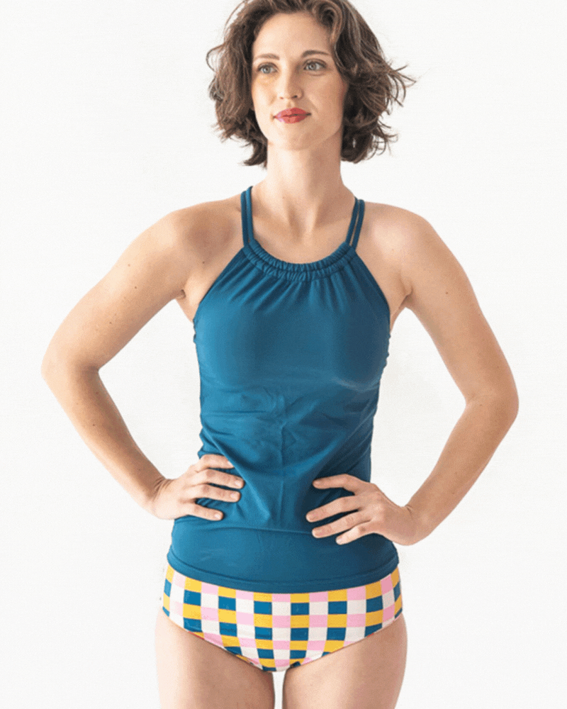 GIF of a woman wearing an Indigo double-cinch swim top and a multi color checkered swim bottom
