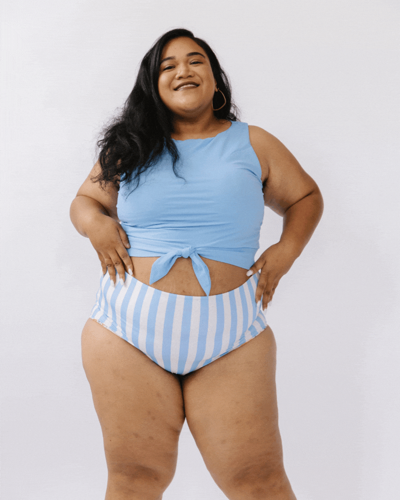 GIF of a woman wearing a peri swim crop top and a peri stripped swim bottom