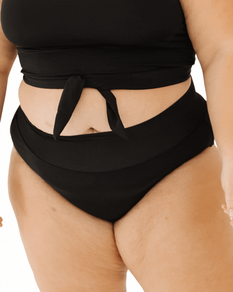 GIF of a woman in black classic swim bottoms