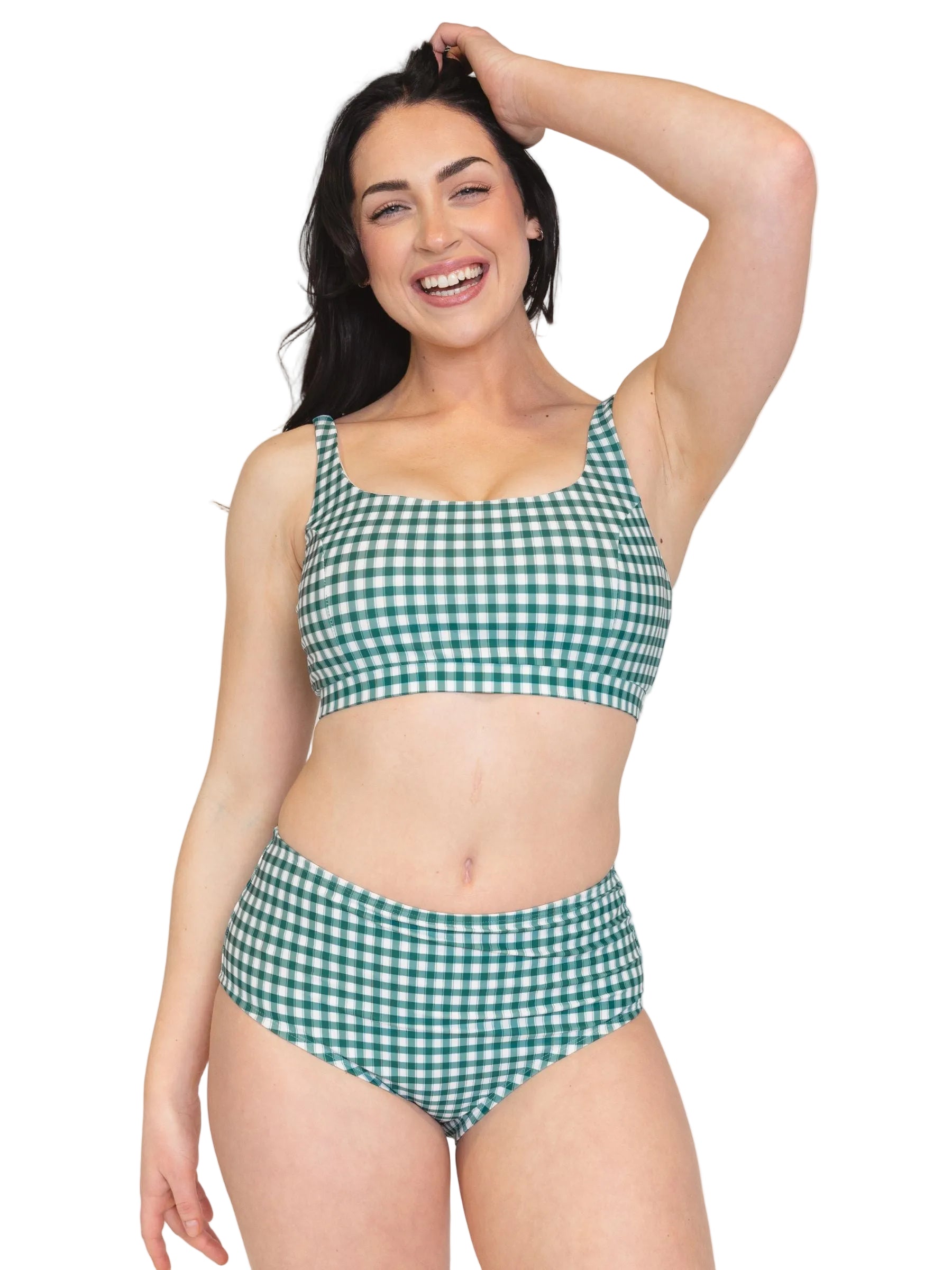 Woman wearing a green and white checkered bikini set on a white background