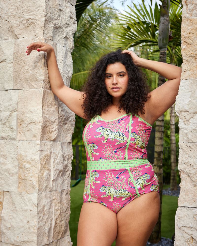 Photo of a woman wearing a bold pink and green print featuring tigers classic one-piece swim suit