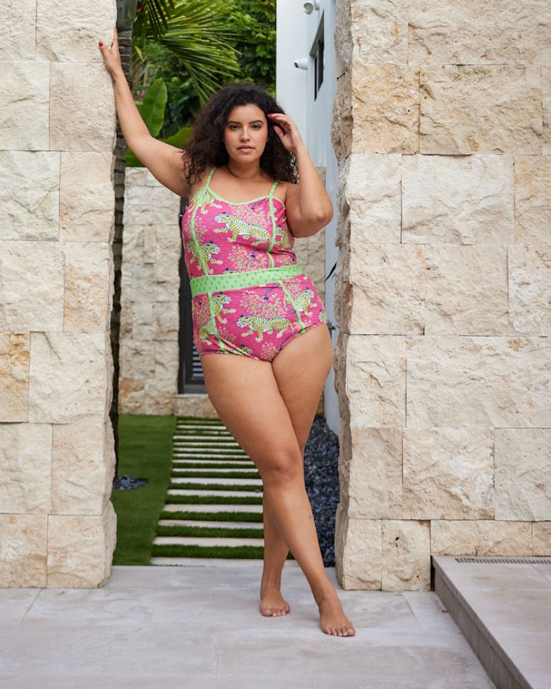 Photo of a woman wearing a bold pink and green print featuring tigers classic one-piece swim suit