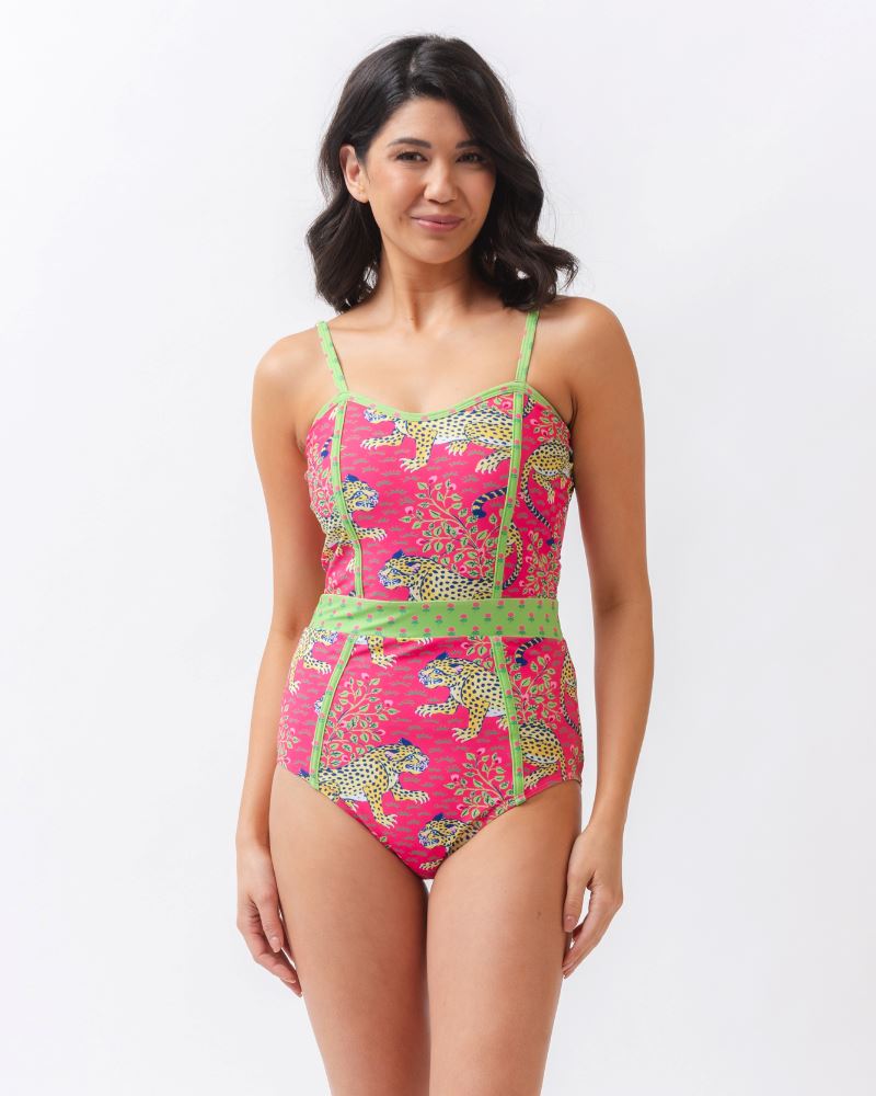 Photo of a woman wearing a bold pink and green print featuring tigers classic one-piece swim suit