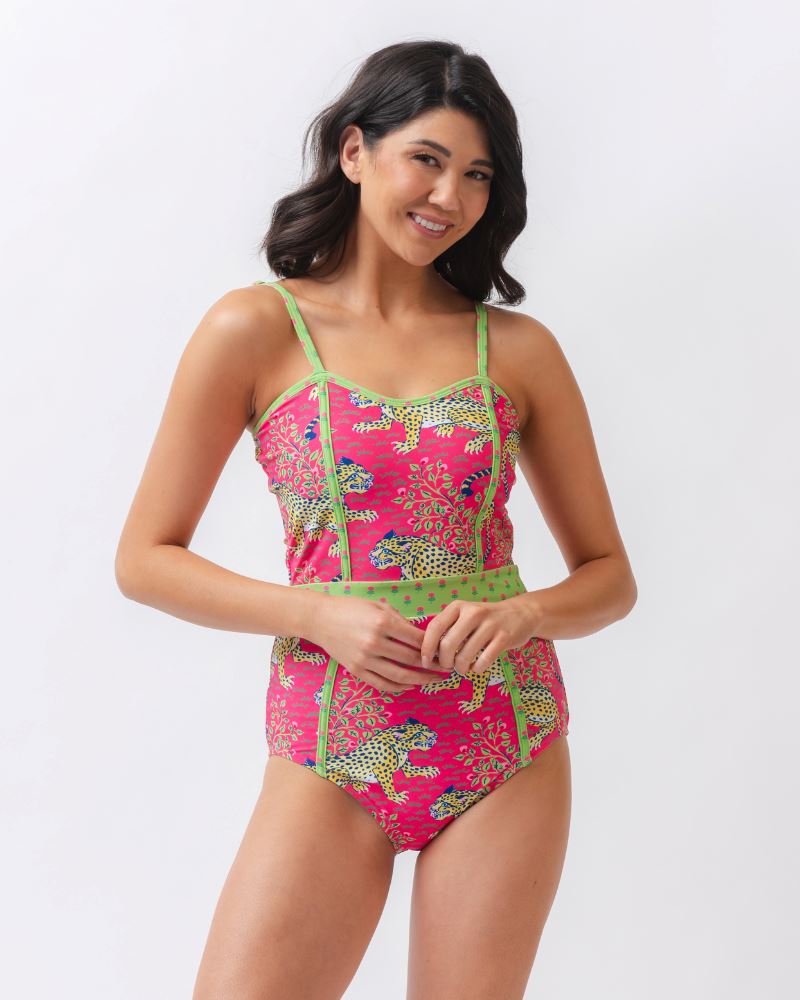 Photo of a woman wearing a bold pink and green print featuring tigers classic one-piece swim suit