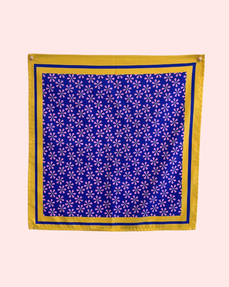 Photo of a purple floral bandanna with yellow boarders