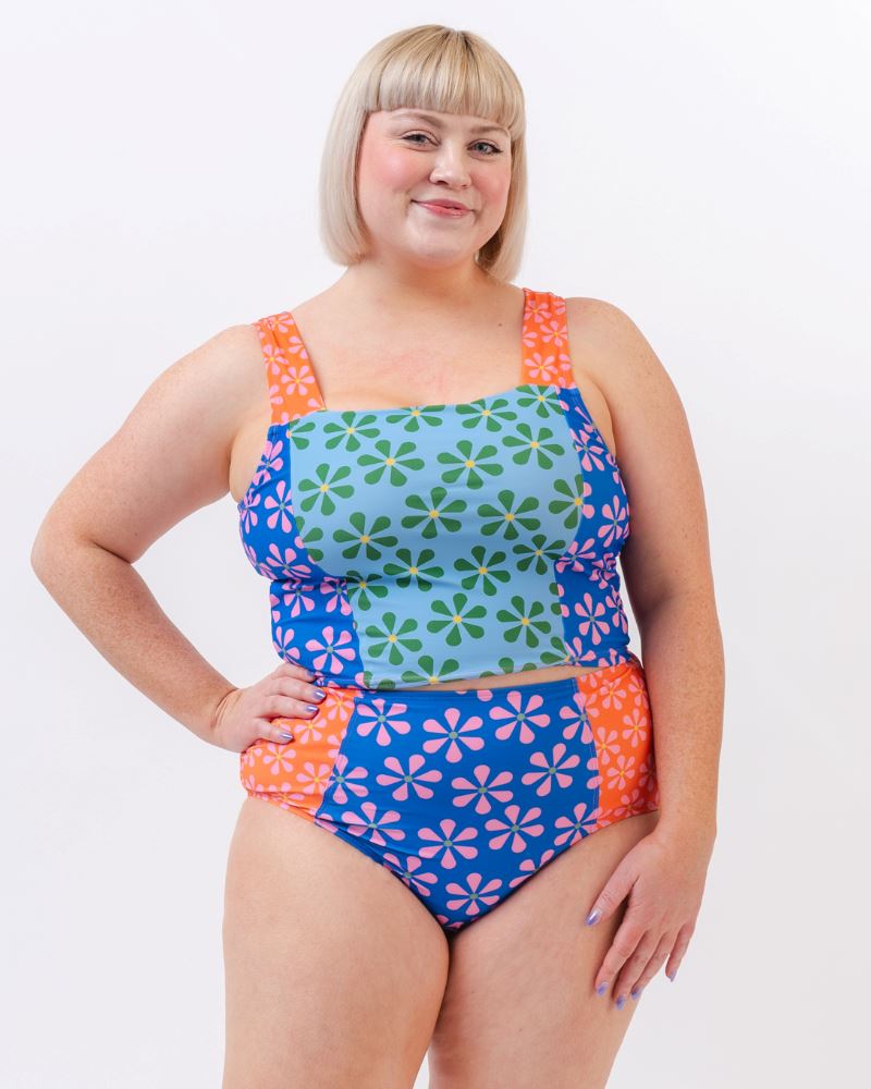Photo of a woman wearing a multi-colored floral square neck swim crop top and a multi-colored floral swim bottom