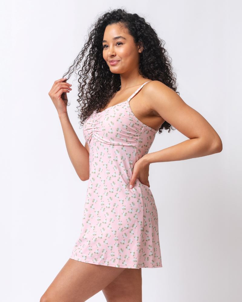 Photo of a woman wearing a pink floral swim dress