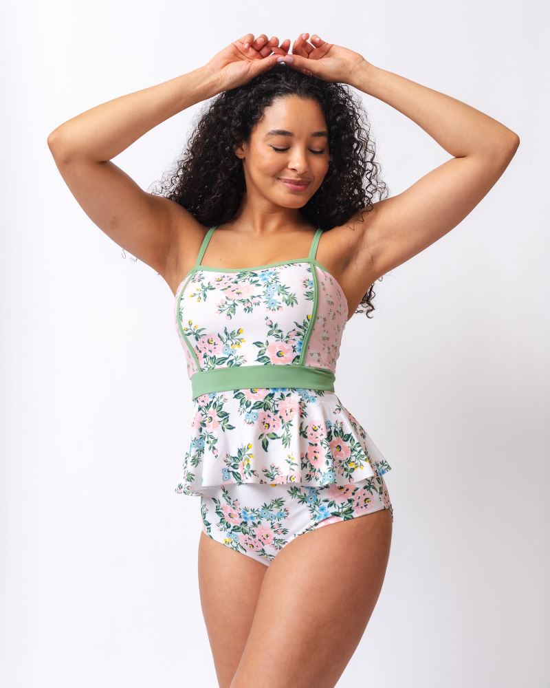 Photo of a woman wearing a pink and white floral swim top with pink and white floral high waist swim bottoms