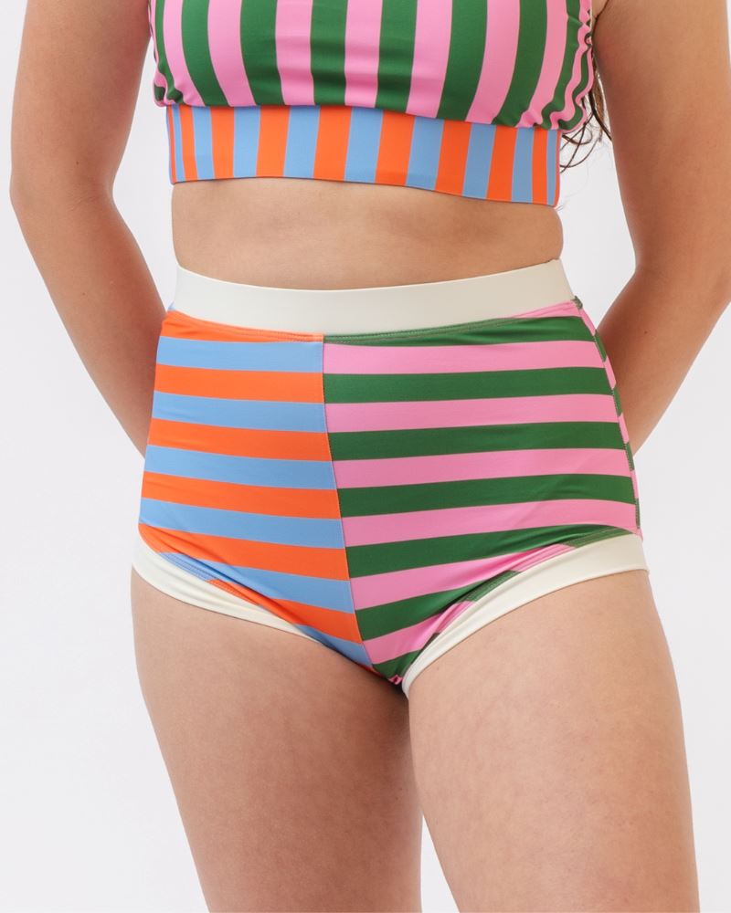 Close-up photo of a woman wearing a multi-colored striped retro swim short bottom