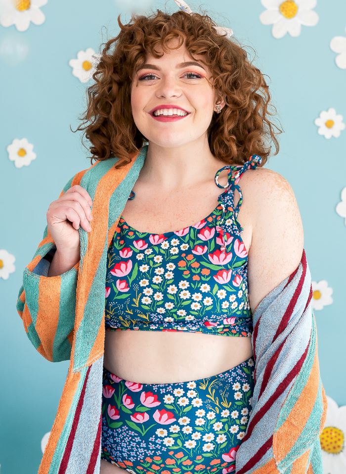 Photo of a woman wearing a Blixen shoulder-tie swim crop top and a Blixen swim bottom