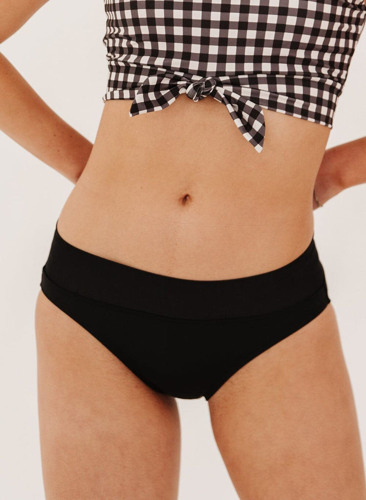 Photo of a woman in black classic swim bottoms
