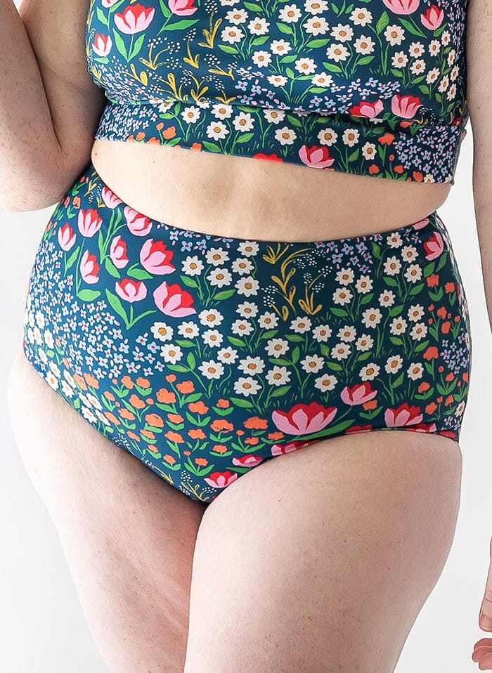 Photo of a woman wearing a Blixen/Indigo reversible swim bottom floral side