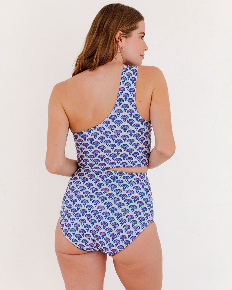 Photo of a woman wearing a Block Floral One-shoulder swim crop top and a Block Floral swim bottom back angle