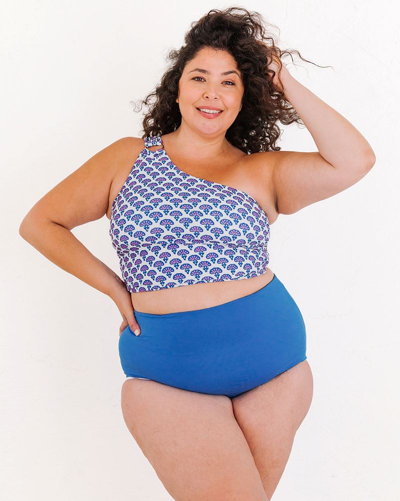 Photo of a woman wearing a Block Floral One-shoulder swim crop top and a Blue swim bottom