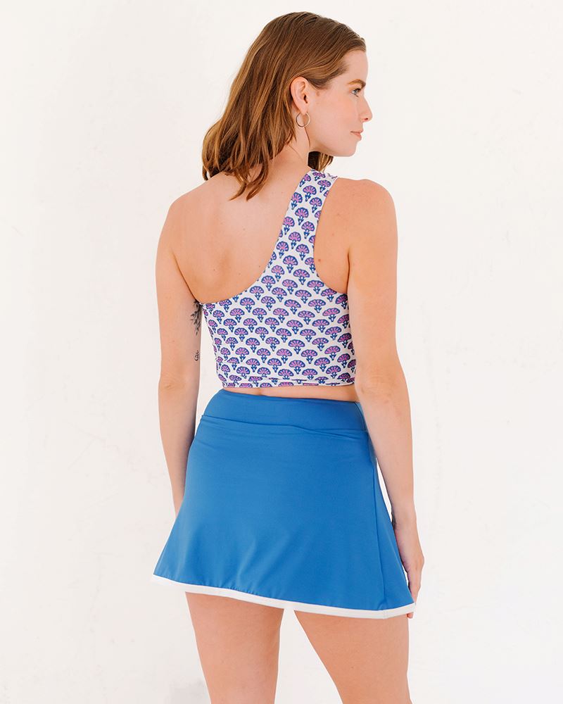 Photo of a woman wearing a Block Floral One-shoulder swim crop top and a capri skirt swim bottom back angle