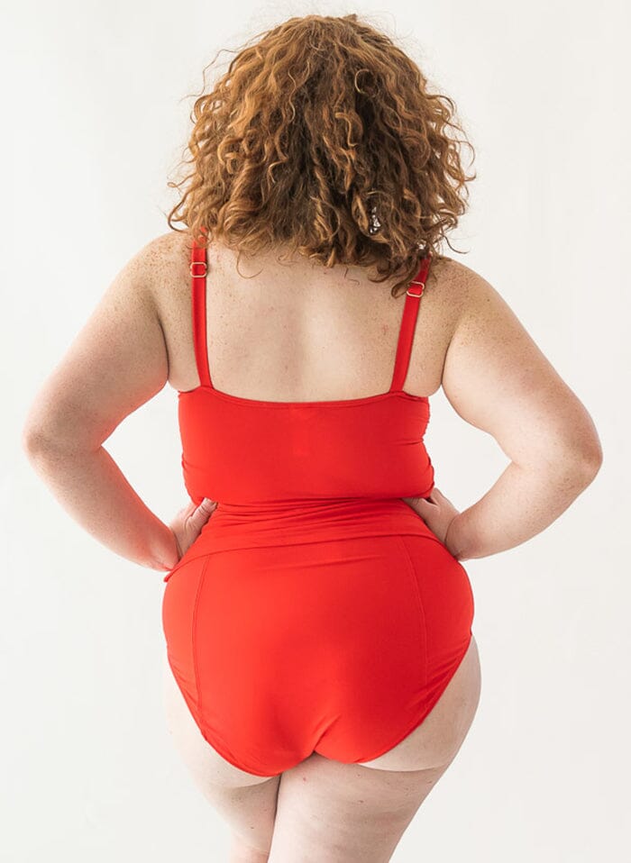 Photo of a woman wearing a red square-neck swim top and a red swim bottom back angle