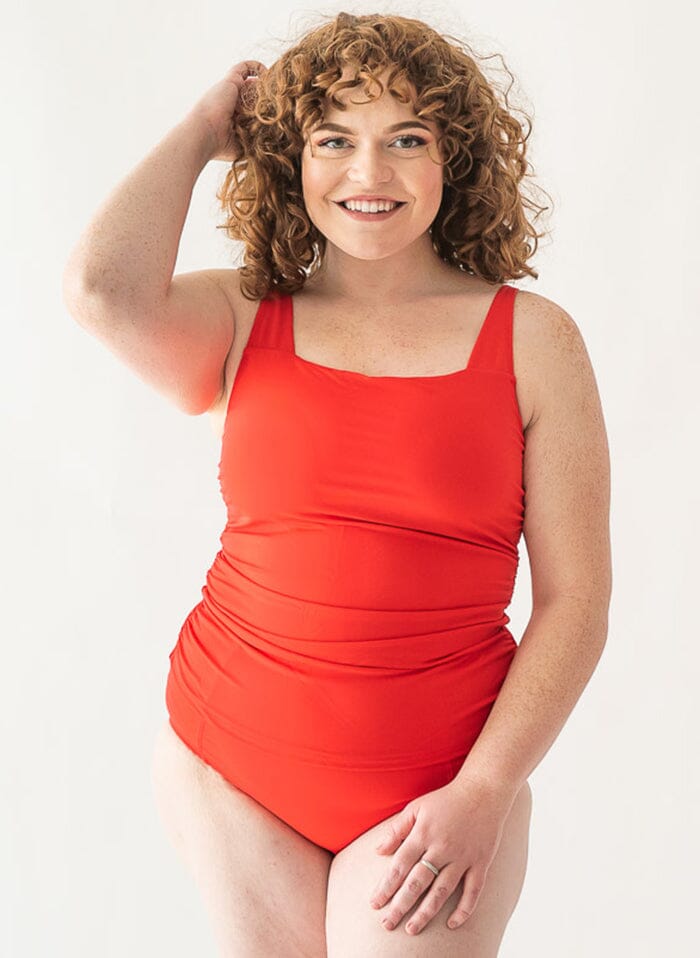 Photo of a woman wearing a red square-neck swim top and a red swim bottom