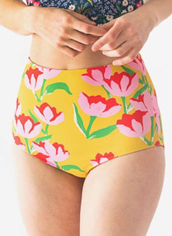 Photo of a woman wearing a Claus/Tage reversible swim bottom Claus side