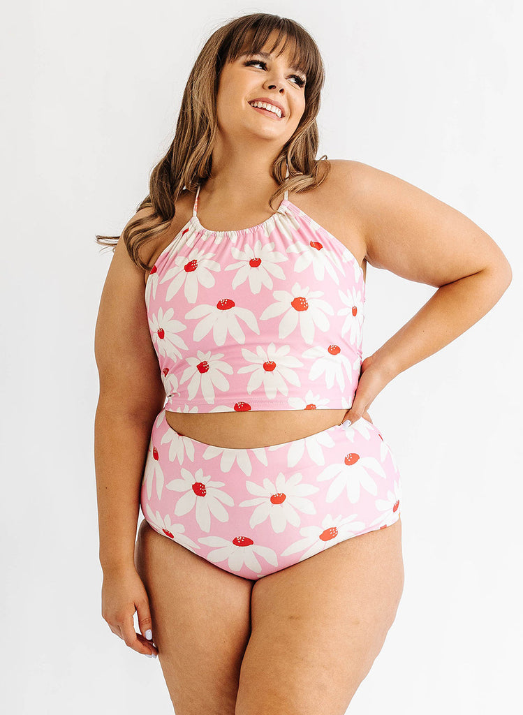 Photo of woman wearing pink floral lace back swim top with pink floral swim bottoms