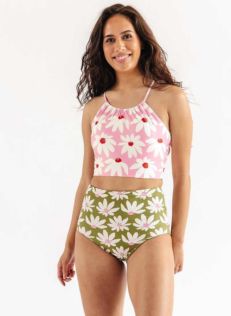 Photo of woman wearing pink floral lace back swim top with green floral swim bottoms