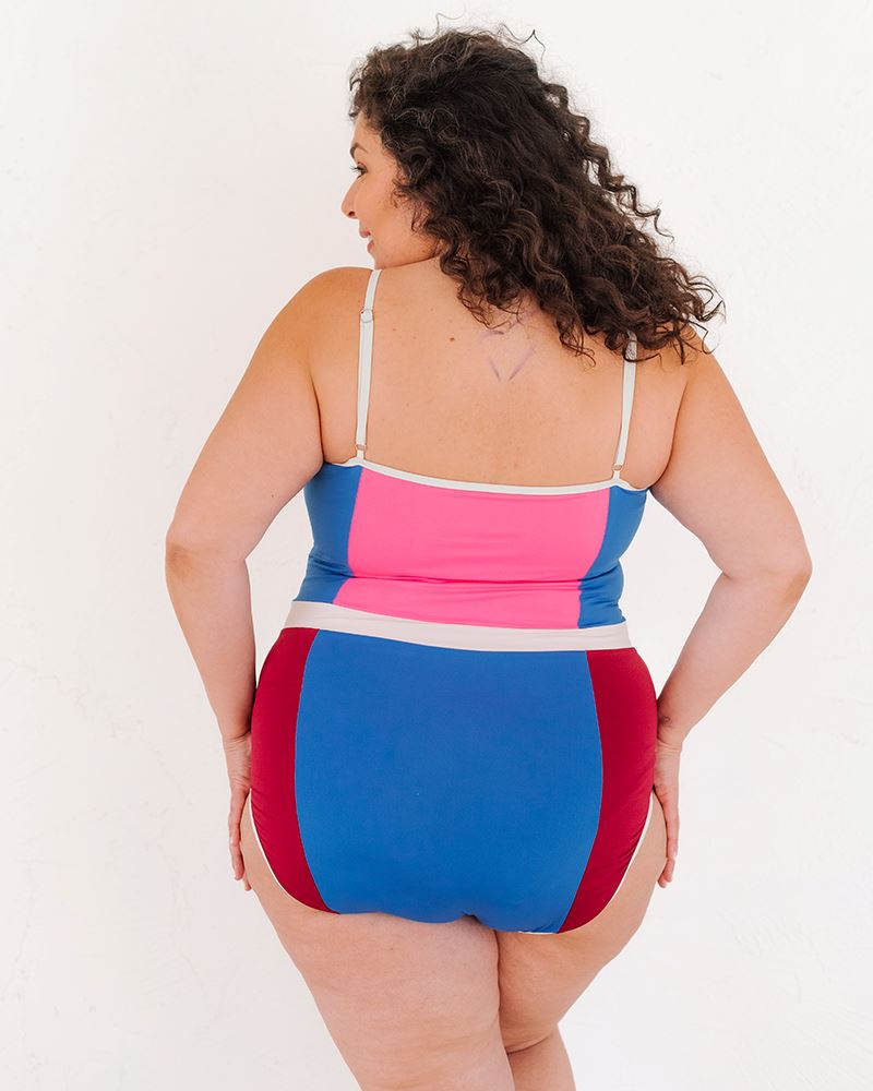 Photo of a woman wearing a Color Block one-piece swim suit back angle