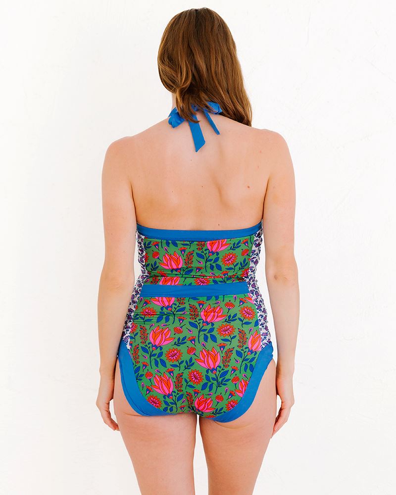 Photo of a woman wearing a Fresco Floral Halter one-piece swim suit back angle