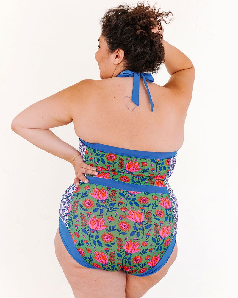 Photo of a woman wearing a Fresco Floral Halter one-piece swim suit back angle