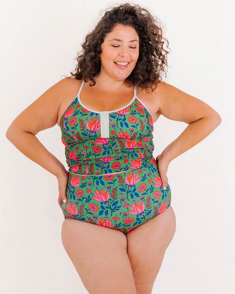 Photo of a woman wearing a Fresco Floral swim crop top and a Fresco floral swim bottom