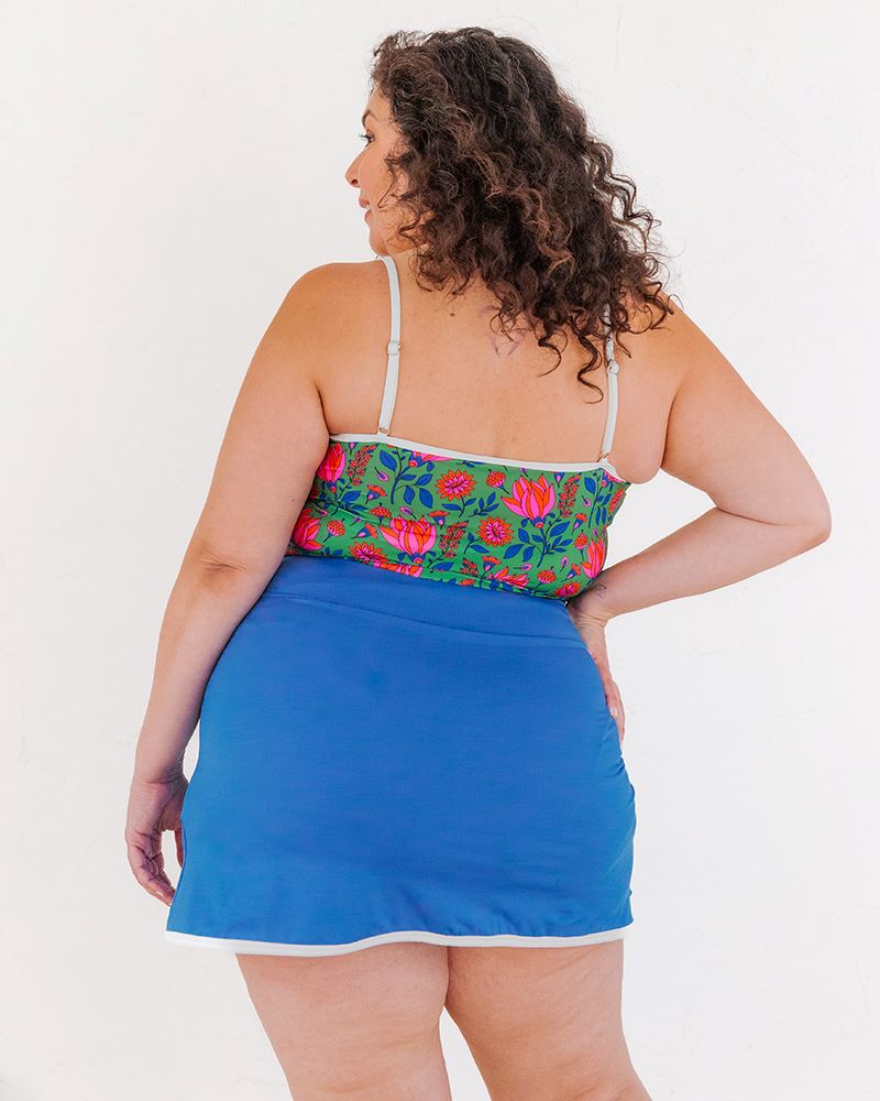 Photo of a woman wearing a Capri swim skirt bottom and a Fresco floral swim crop top back angle