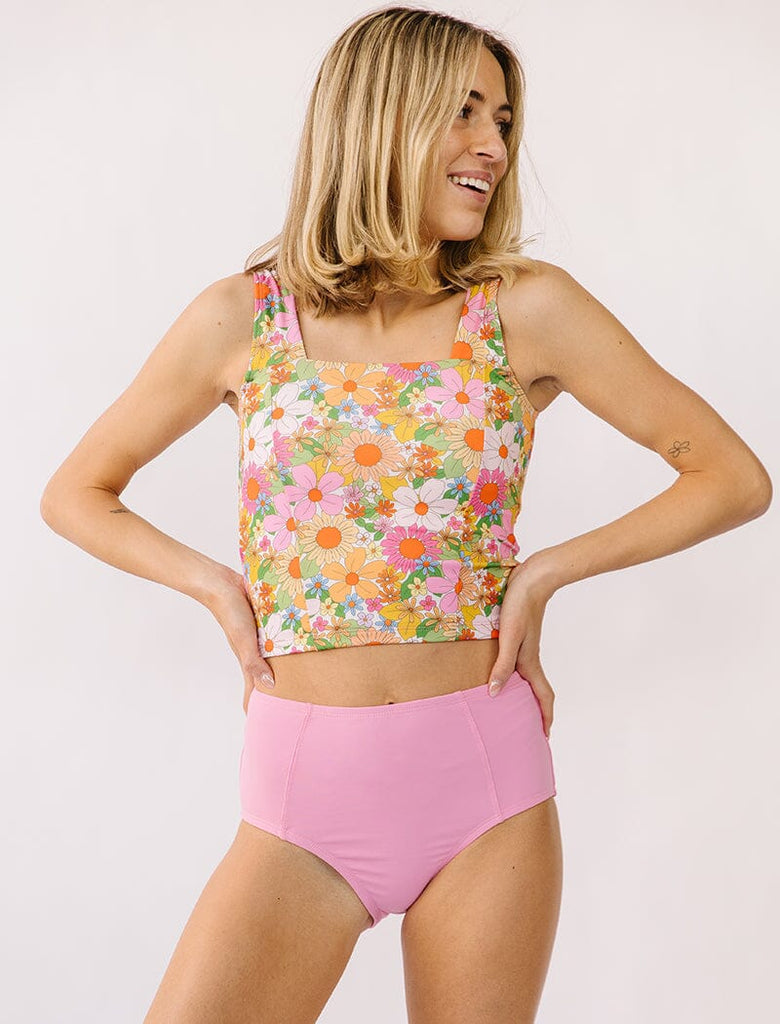 Photo of woman wearing multi colored square neck swim top with pink swim bottoms
