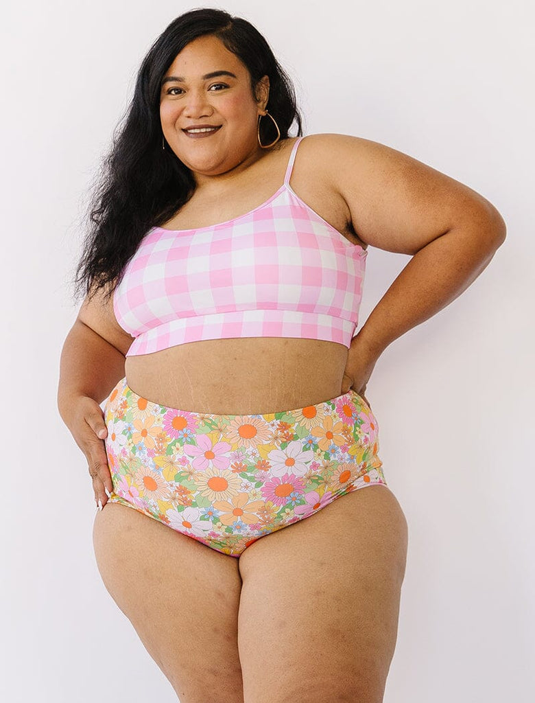 Photo of woman wearing pink gingham bralette swim top with multi colored floral swim bottoms