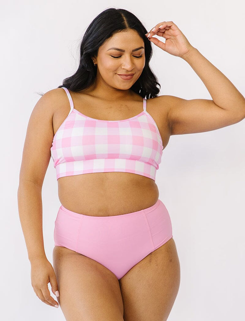 Photo of woman wearing pink gingham bralette swim top with pink swim bottoms