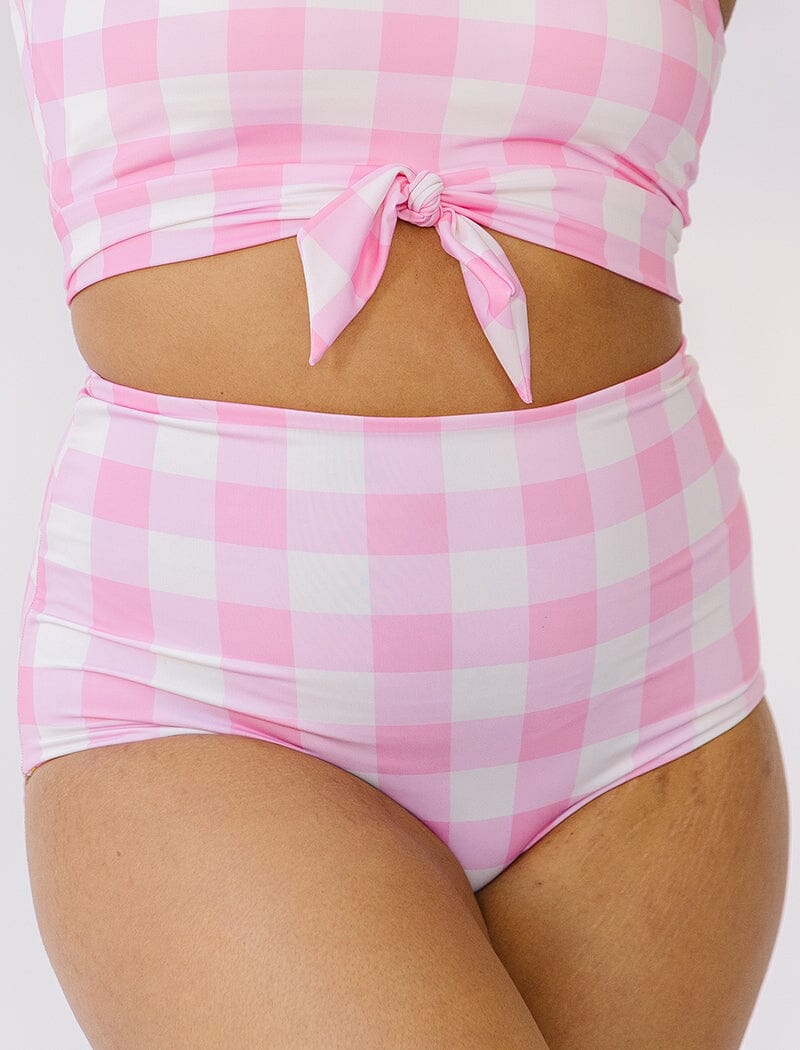 Photo of woman wearing pink gingham reversible side swim bottoms
