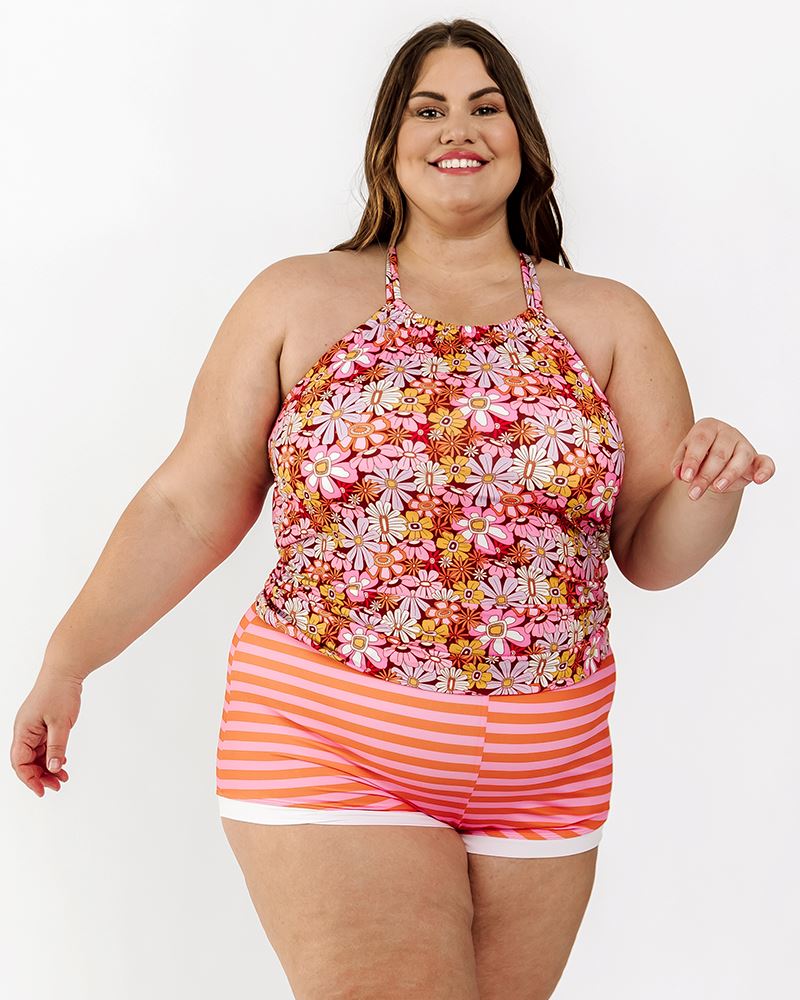 Photo of a woman wearing a Daphne floral retro swim short bottom and a multi color floral double-cinch swim top
