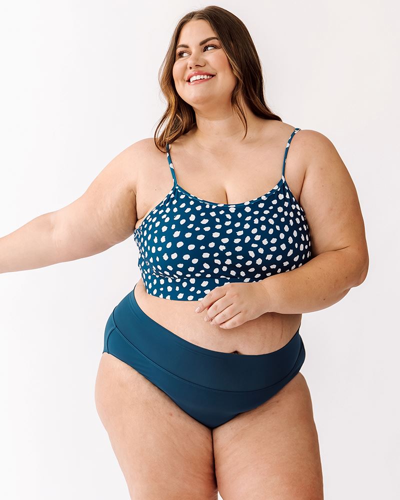 Photo of a woman wearing an Indigo dot swim bralette and an Indigo classic bottom
