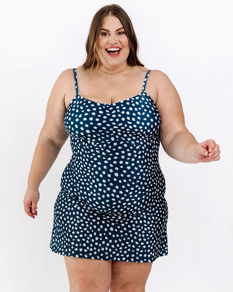 Photo of a woman wearing an Indigo dot swim dress one-piece