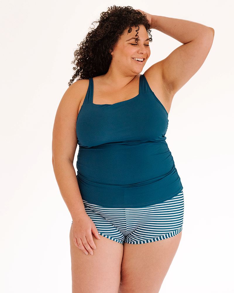 Photo of a woman wearing an Indigo square neck swim top and an Indigo stripe swim short bottom