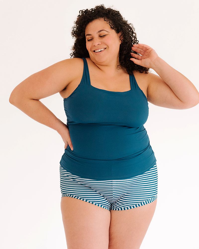 Photo of a woman wearing an Indigo square neck swim top and an Indigo and white stripe swim short bottom
