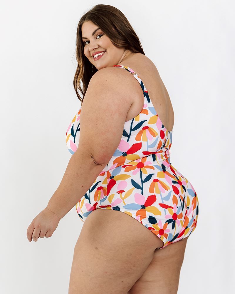 Photo of a woman wearing a June floral one-piece swim suit side angle
