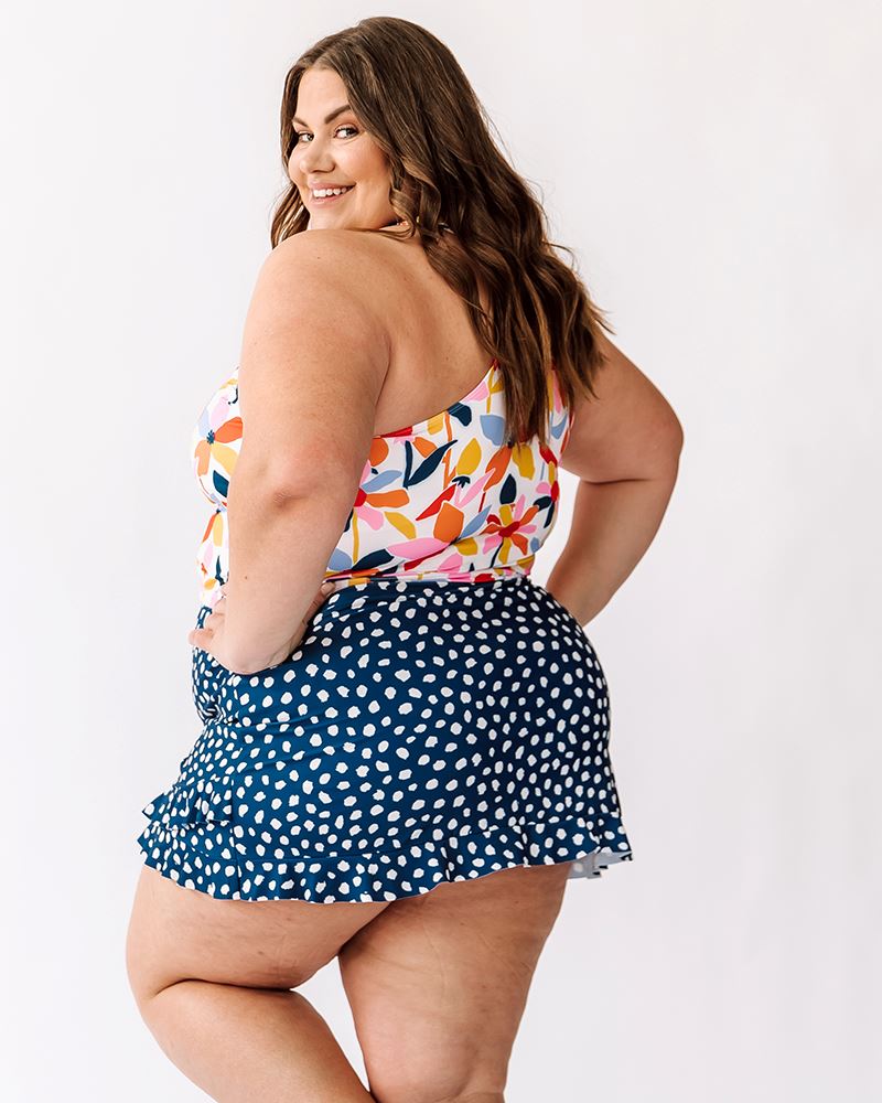 Photo of a woman wearing Indigo Dot swim skirt and June Floral racer back side angle