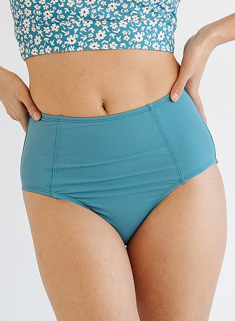 Photo of woman wearing blue high waist swim bottoms