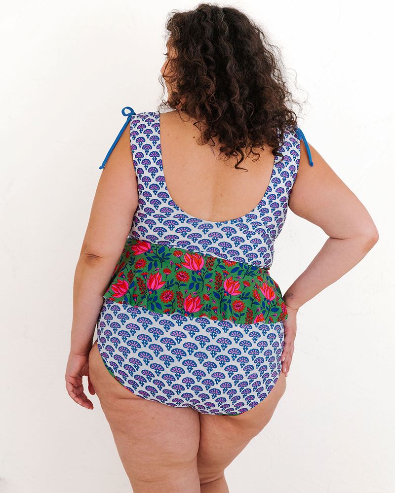 Photo of a woman wearing a Block floral peplum swim top and a Block floral swim bottom back angle