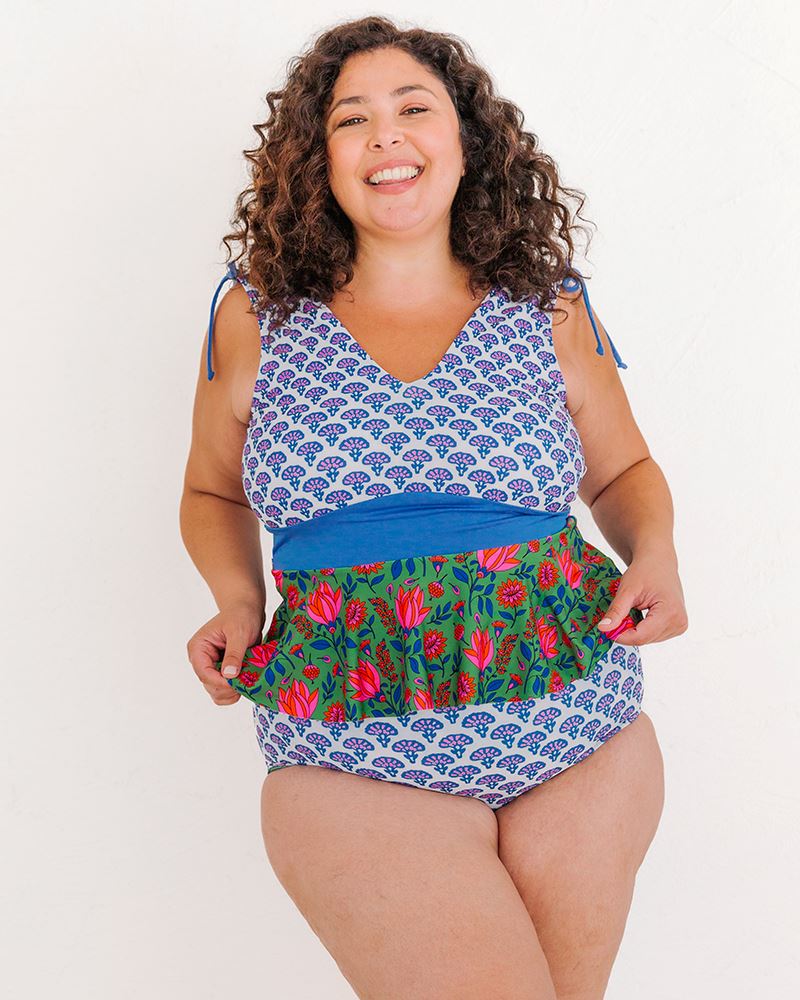 Photo of a woman wearing a Block floral peplum swim top and a Block floral swim bottom