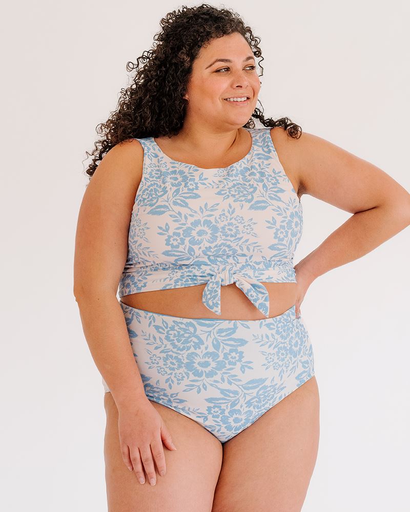 Photo of a woman wearing a Peri Lace knotted swim crop top and a Peri Lace swim bottom
