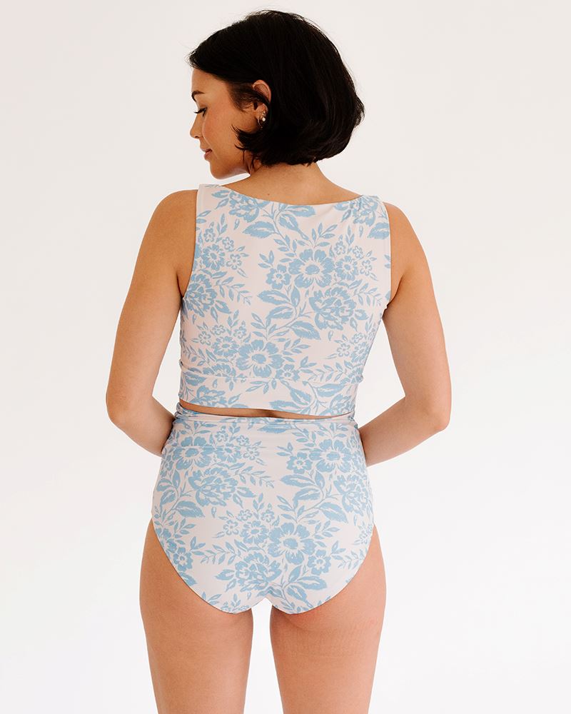 Photo of a woman wearing a Peri Lace knotted swim crop top and a Peri Lace swim bottom back angle